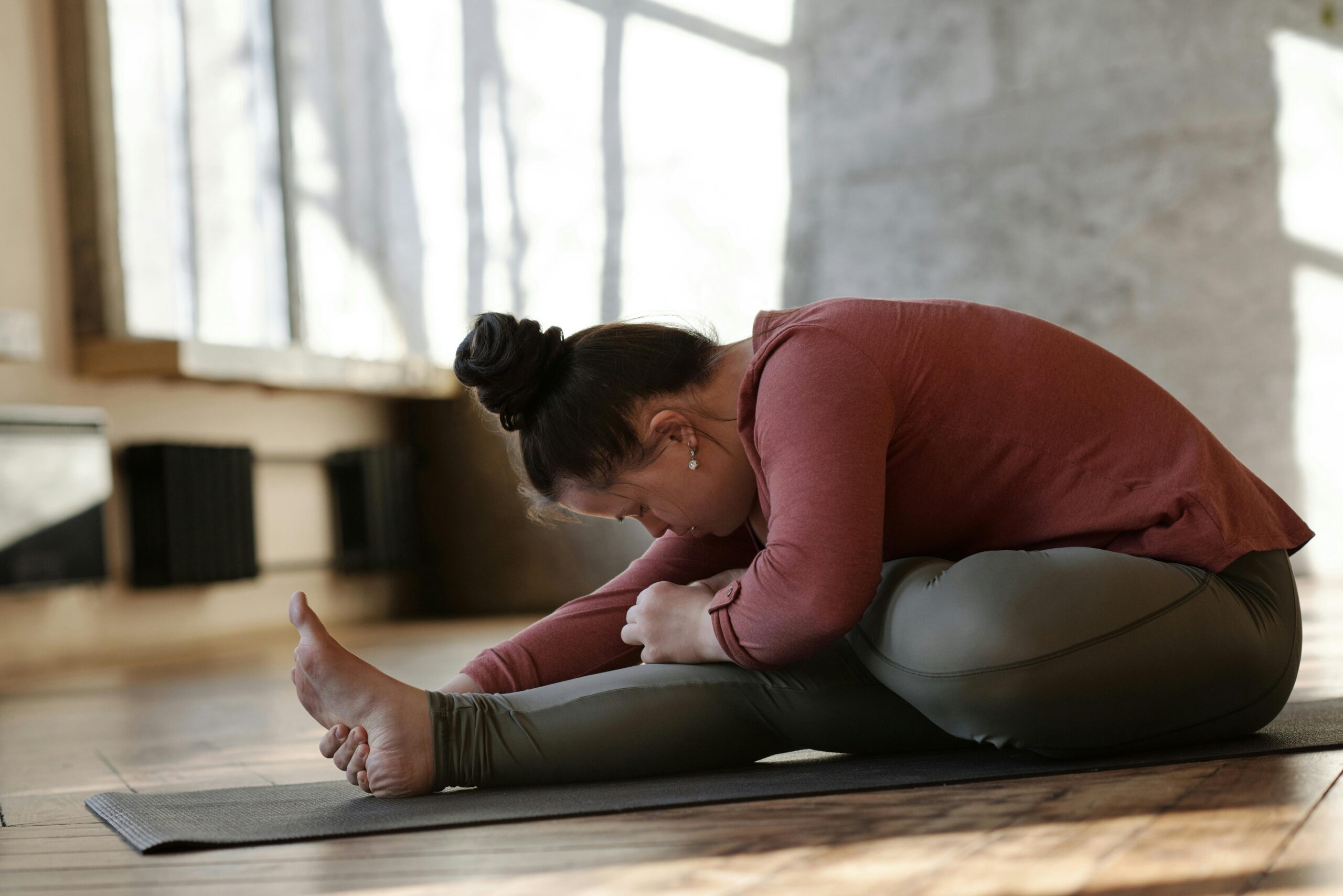 Image of a developmentally disabled student performing yoga